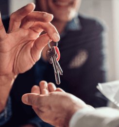 House keys being handed to a person