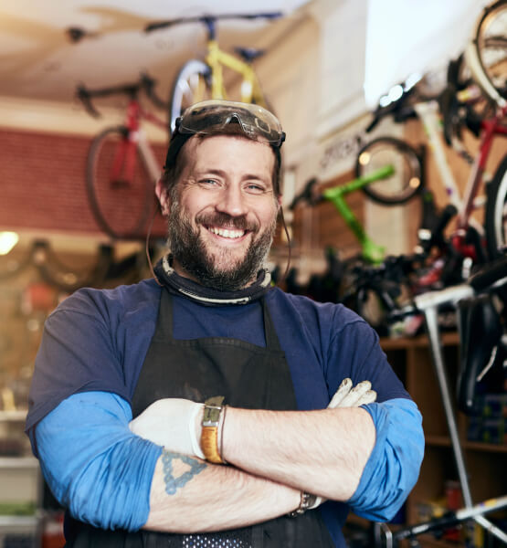 Business owner smiling in his bike shop