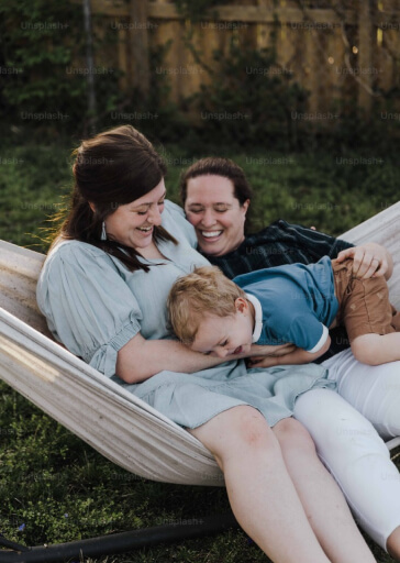 Two women and son in hammock