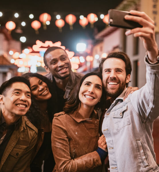 Group of adults taking a selfie with phone
